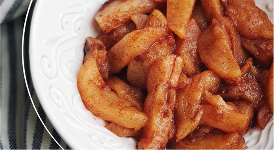 Warm cinnamon apples in a glossy caramel sauce, prepared for delightful dessert or side dish.