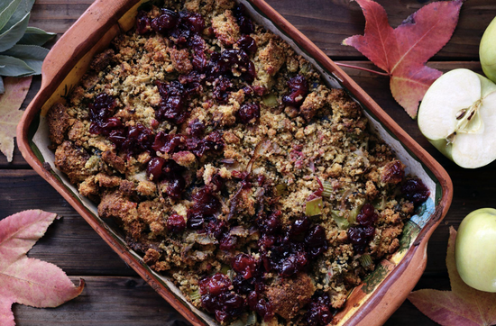 Delicious autumn casserole with savory stuffing, cranberries, and fresh apples in a rustic dish.