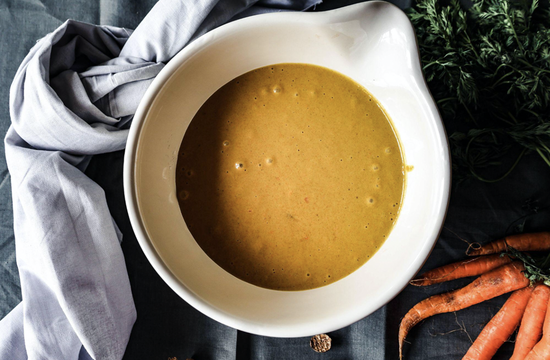 Delicious Chairmans Gravy soup served in an elegant bowl, garnished with fresh carrots.