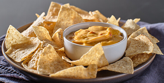 Mexican Hot Queso Cheese Dip With Corn Tortilla Chips On Plate