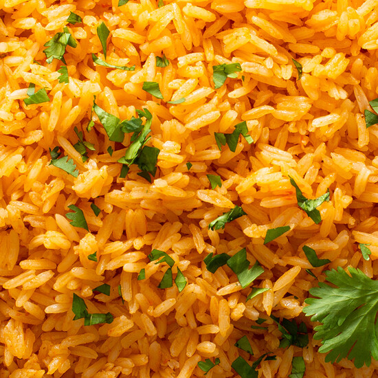 Delicious golden rice with cilantro, featuring fluffy grains and vibrant colors, perfect for any meal.