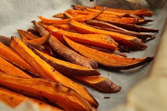 Delicious sweet potato fries on a baking sheet, perfect for healthy snacking and side dishes.